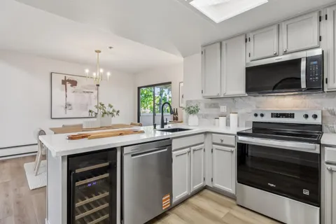 a kitchen with stainless steel appliances granite countertop a stove and a sink