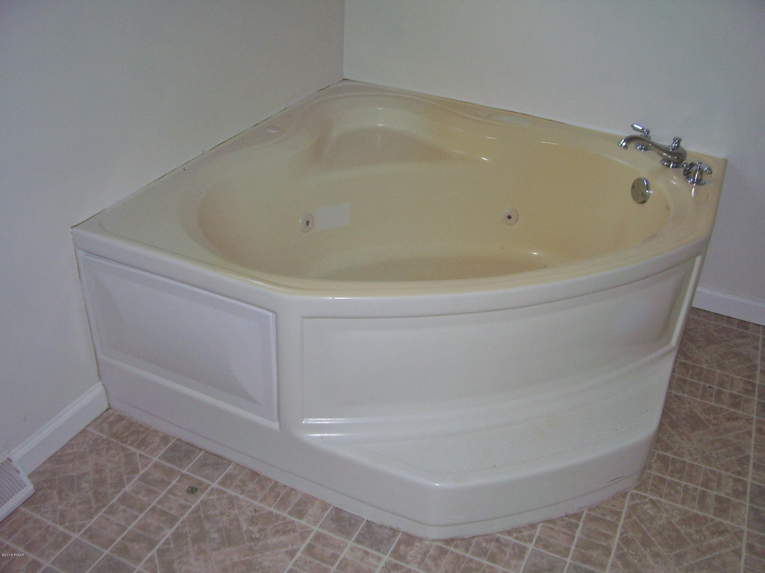13 W Road Hawley, PA 18428 - Photo 15 of 26 a bath tub sitting in a bathroom
