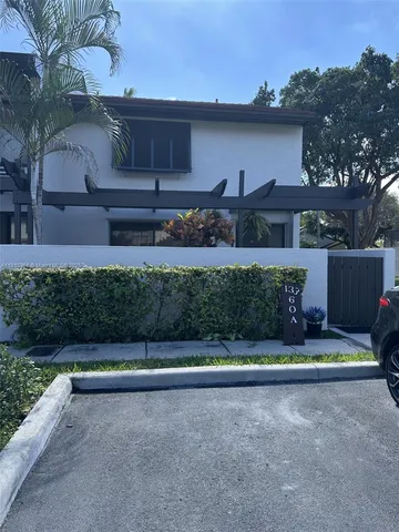 a front view of a house with lots of green space