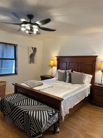 a bedroom with bed and a chandelier