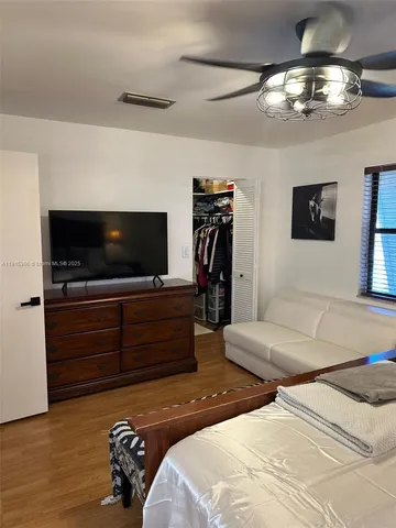 a bedroom with a bed and a flat screen tv