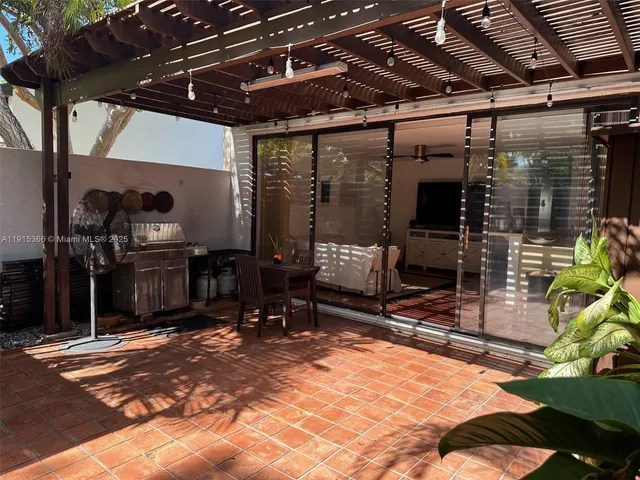 a view of backyard with plants and outdoor seating