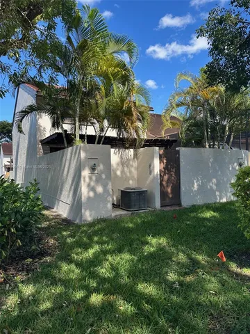 a view of a yard with palm trees
