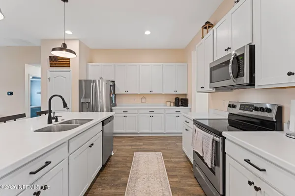 a kitchen with stainless steel appliances granite countertop a sink and a stove