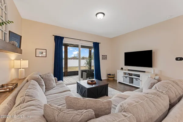 a living room with furniture and a flat screen tv