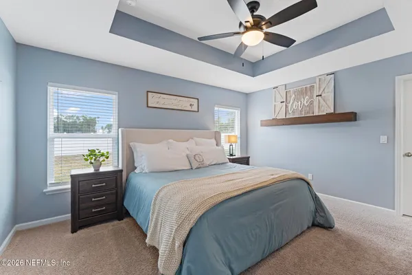 a bedroom with a bed and a chandelier