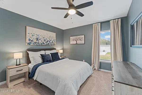 a bedroom with a bed and a painting on the wall