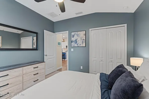 a bedroom with a bed and cabinets