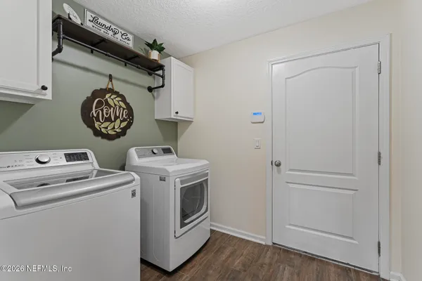 a view of washer and dryer with wooden floor