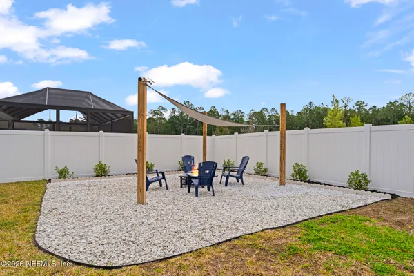 a front view of the house with yard and trees