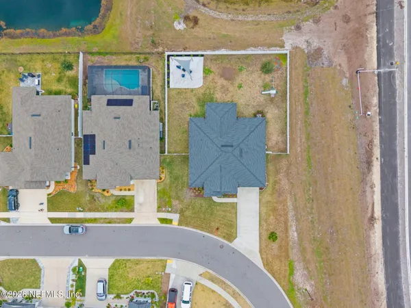 a view of a patio with chairs next to a yard