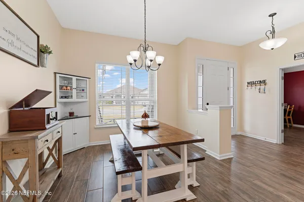 a view of a dining room with furniture window and wooden floor