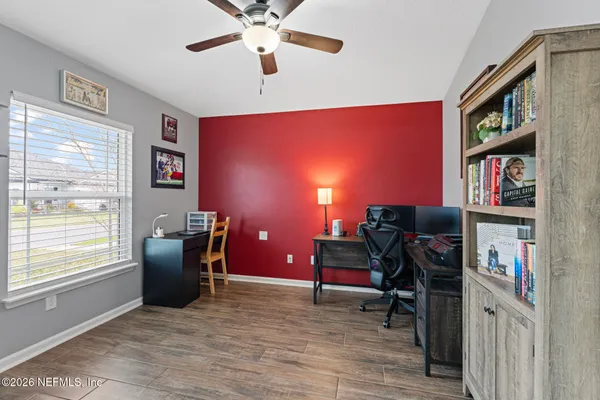 a view of a workspace with furniture and a window