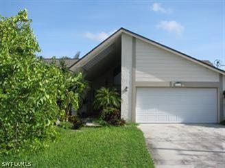 a front view of house with green space