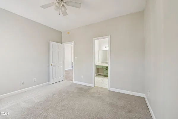 a view of empty room with wooden floor and window