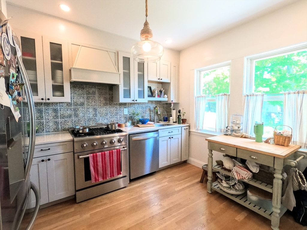 12 Searle Road, Unit 12 Boston, MA 02132 - Photo 6 of 35 a kitchen with a stove a sink and cabinets