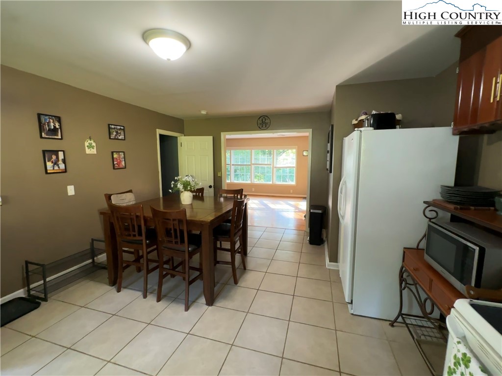 320 North Main Street Jefferson, NC 28640 - Photo 11 of 28 a kitchen with stainless steel appliances a refrigerator and a dining table