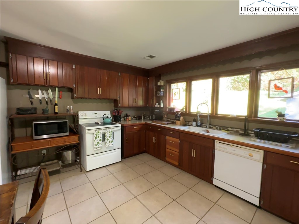 320 North Main Street Jefferson, NC 28640 - Photo 13 of 28 a kitchen with a sink appliances and cabinets