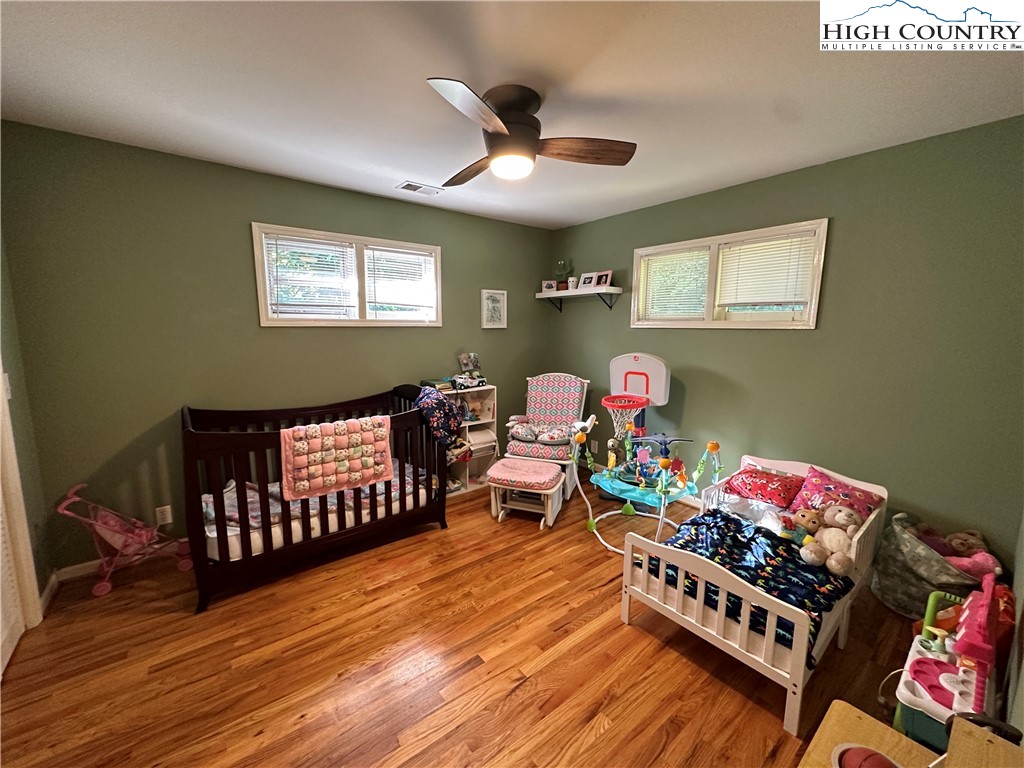 320 North Main Street Jefferson, NC 28640 - Photo 16 of 28 a bed room with furniture and a wooden floor
