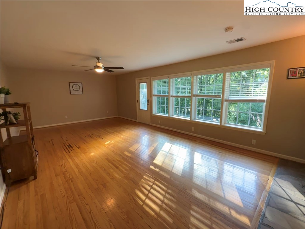 320 North Main Street Jefferson, NC 28640 - Photo 7 of 28 an empty room with wooden floor and windows