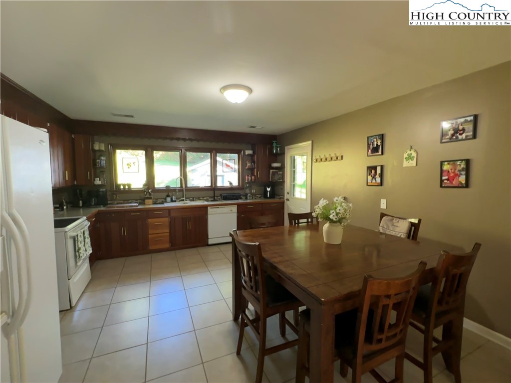 320 North Main Street Jefferson, NC 28640 - Photo 10 of 28 a kitchen with a dining table chairs and refrigerator