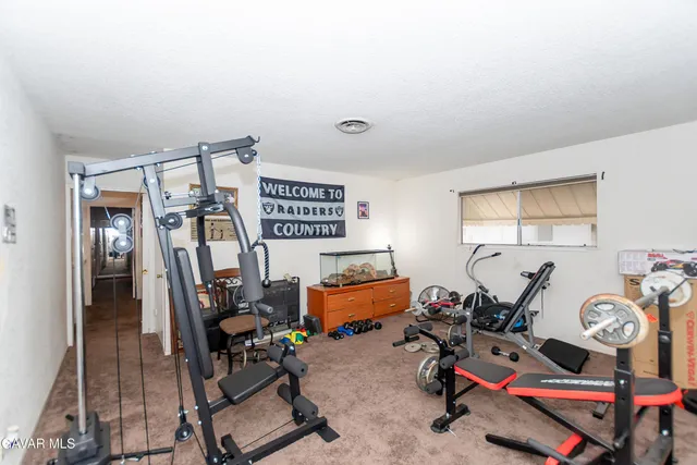 a bedroom with furniture and a gym equipment