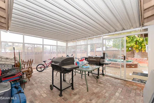 a view of a patio with table and chairs and couches with wooden floor and fence