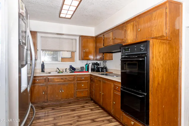 a kitchen with stainless steel appliances a refrigerator and a sink