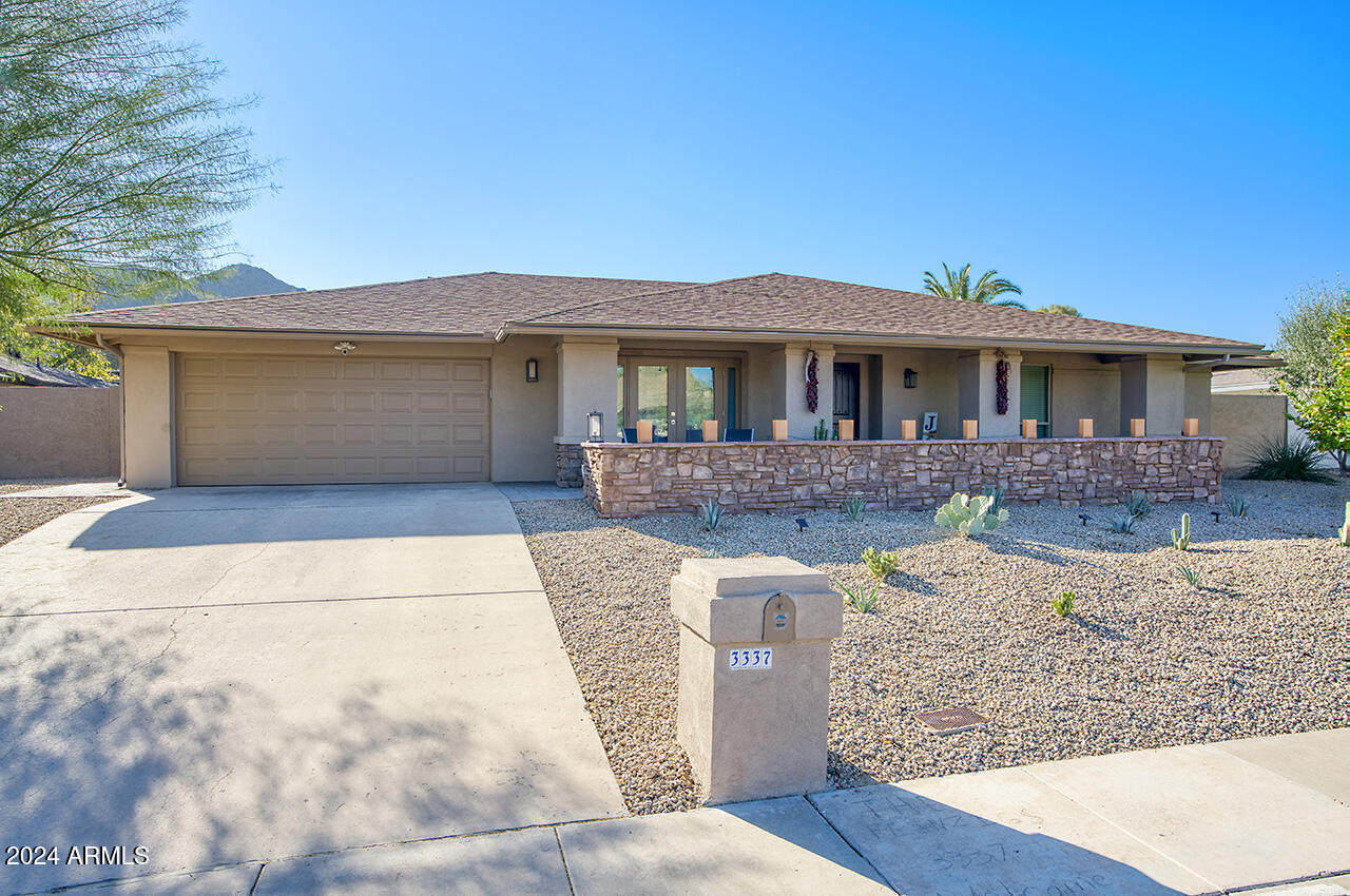 3337 East Las Rocas Drive Phoenix, AZ 85028 - Photo 2 of 22 a front view of a house with a yard