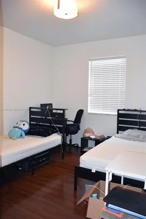 a bed room with a bed and a window