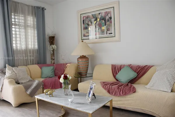 a living room with furniture and a large window