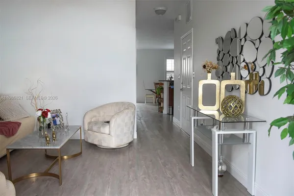 a living room with furniture and wooden floor