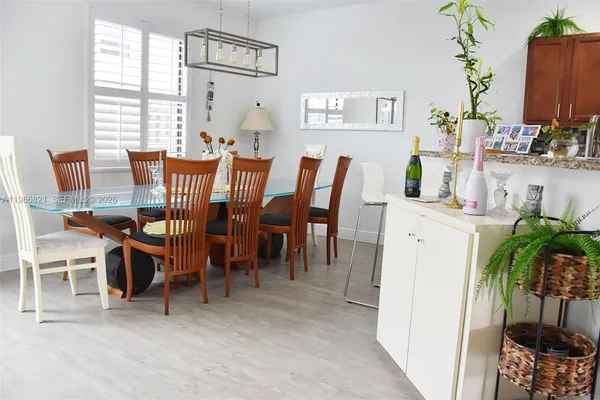 a view of a dining room with furniture and a potted plant