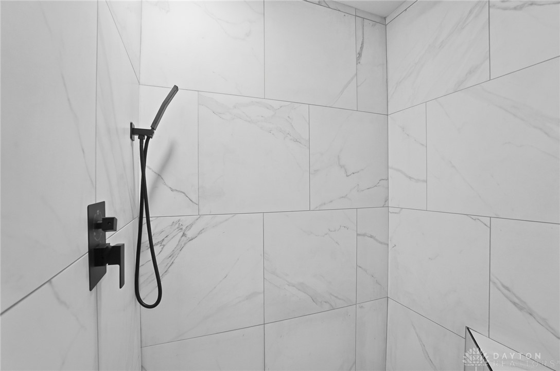 25 Englewood Road Springfield, OH 45504 - Photo 27 of 66 This modern bathroom features sleek tiled walls, and floors.