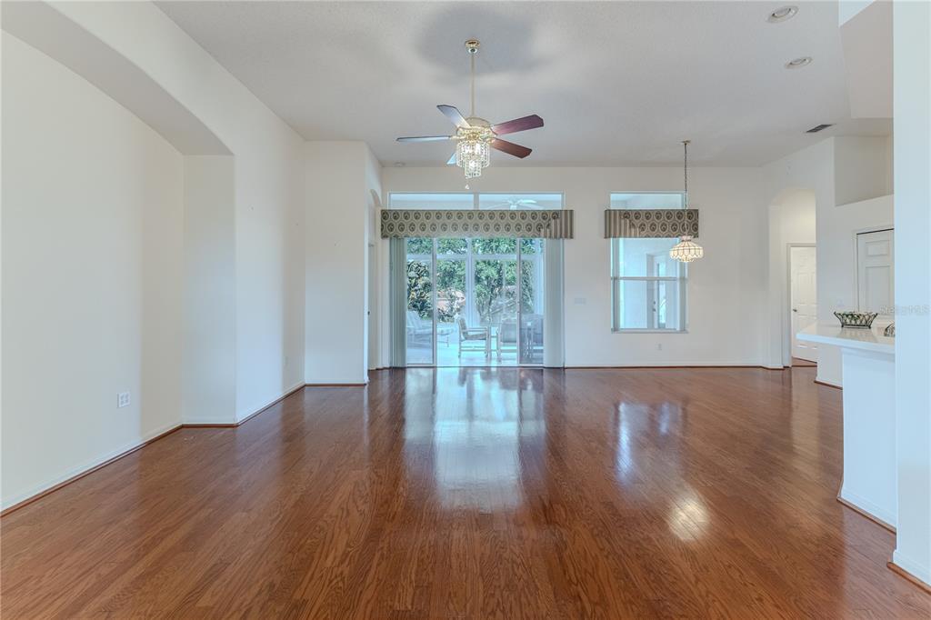 239 Longleaf Court Spring Hill, FL 34609 - Photo 12 of 55 a view of an empty room with wooden floor and a window