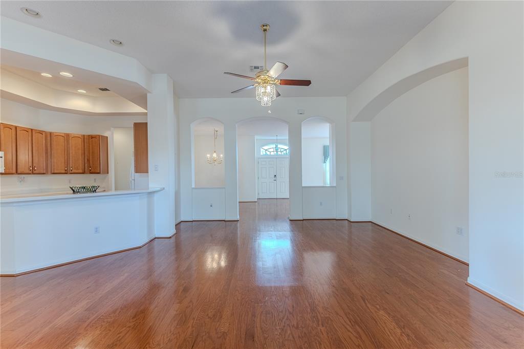239 Longleaf Court Spring Hill, FL 34609 - Photo 15 of 55 a view of an empty room and window and wooden floor
