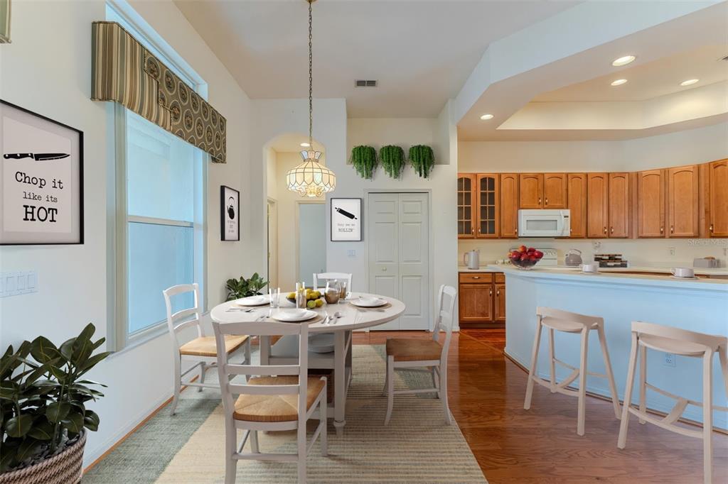 239 Longleaf Court Spring Hill, FL 34609 - Photo 18 of 55 a dining room with stainless steel appliances kitchen island granite countertop a dining table chairs and a oven