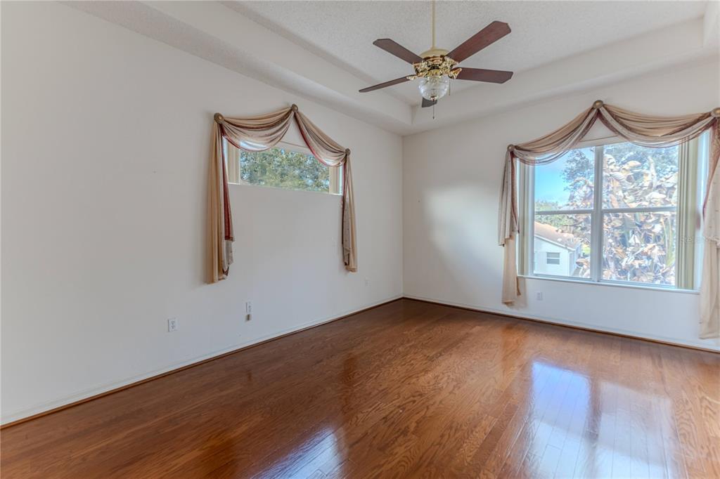 239 Longleaf Court Spring Hill, FL 34609 - Photo 25 of 55 a view of an empty room with a window and wooden floor