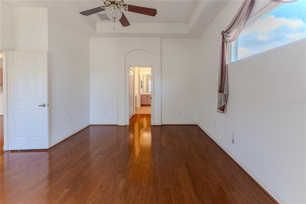239 Longleaf Court Spring Hill, FL 34609 - Photo 26 of 55 a view of empty room with wooden floor and fan