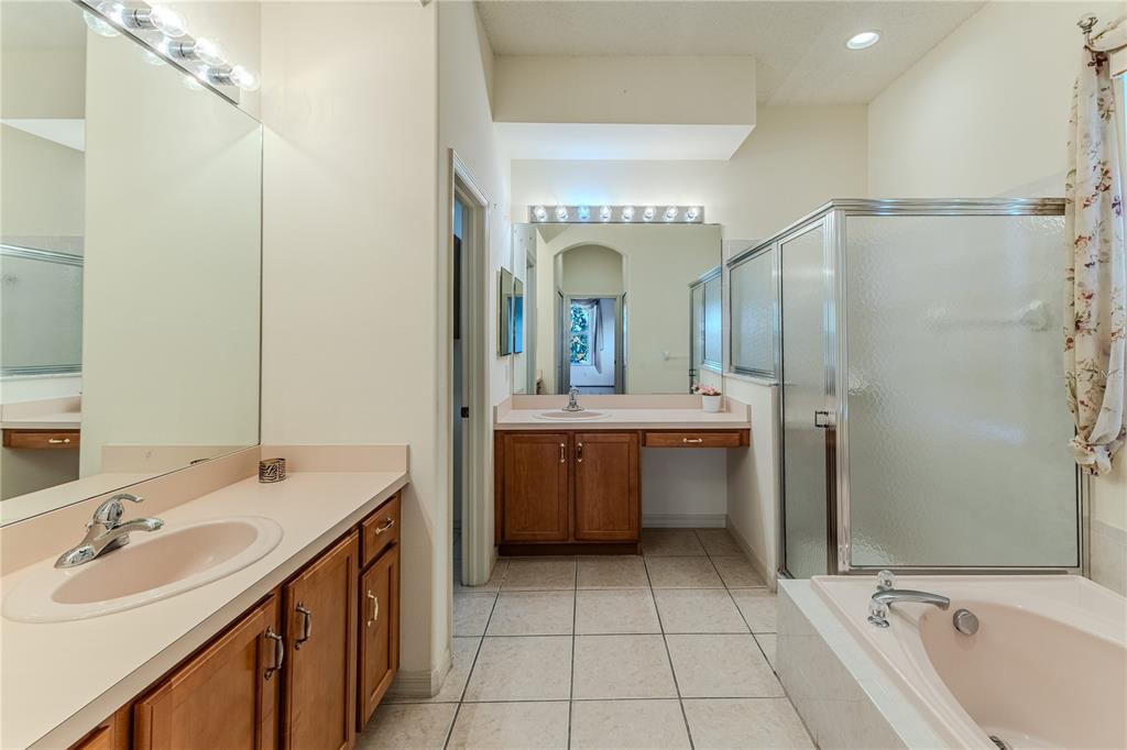 239 Longleaf Court Spring Hill, FL 34609 - Photo 29 of 55 a bathroom with a double vanity sink mirror and shower