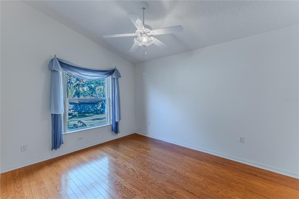 239 Longleaf Court Spring Hill, FL 34609 - Photo 33 of 55 an empty room with wooden floor and windows