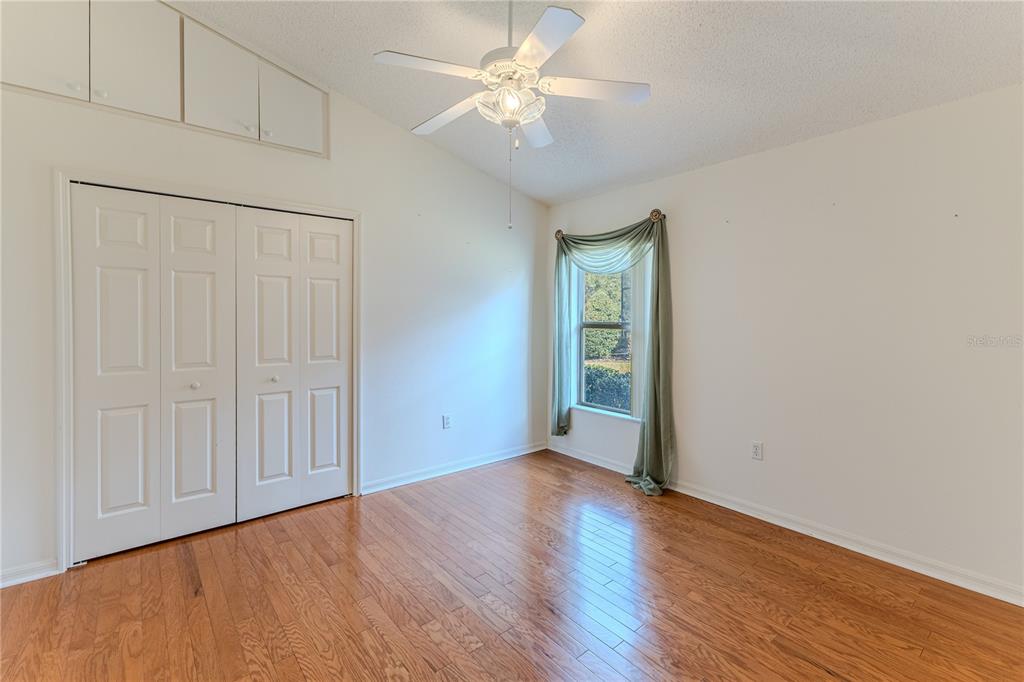 239 Longleaf Court Spring Hill, FL 34609 - Photo 41 of 55 an empty room with wooden floor closet and windows