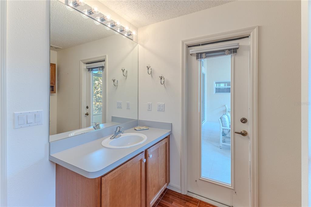 239 Longleaf Court Spring Hill, FL 34609 - Photo 46 of 55 a bathroom with a sink a mirror and a shower