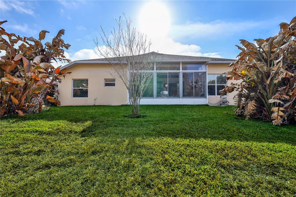 239 Longleaf Court Spring Hill, FL 34609 - Photo 55 of 55 a view of a house with a yard and potted plants