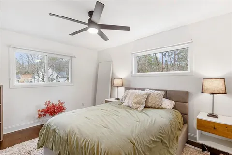 a bedroom with a bed and a painting on the wall