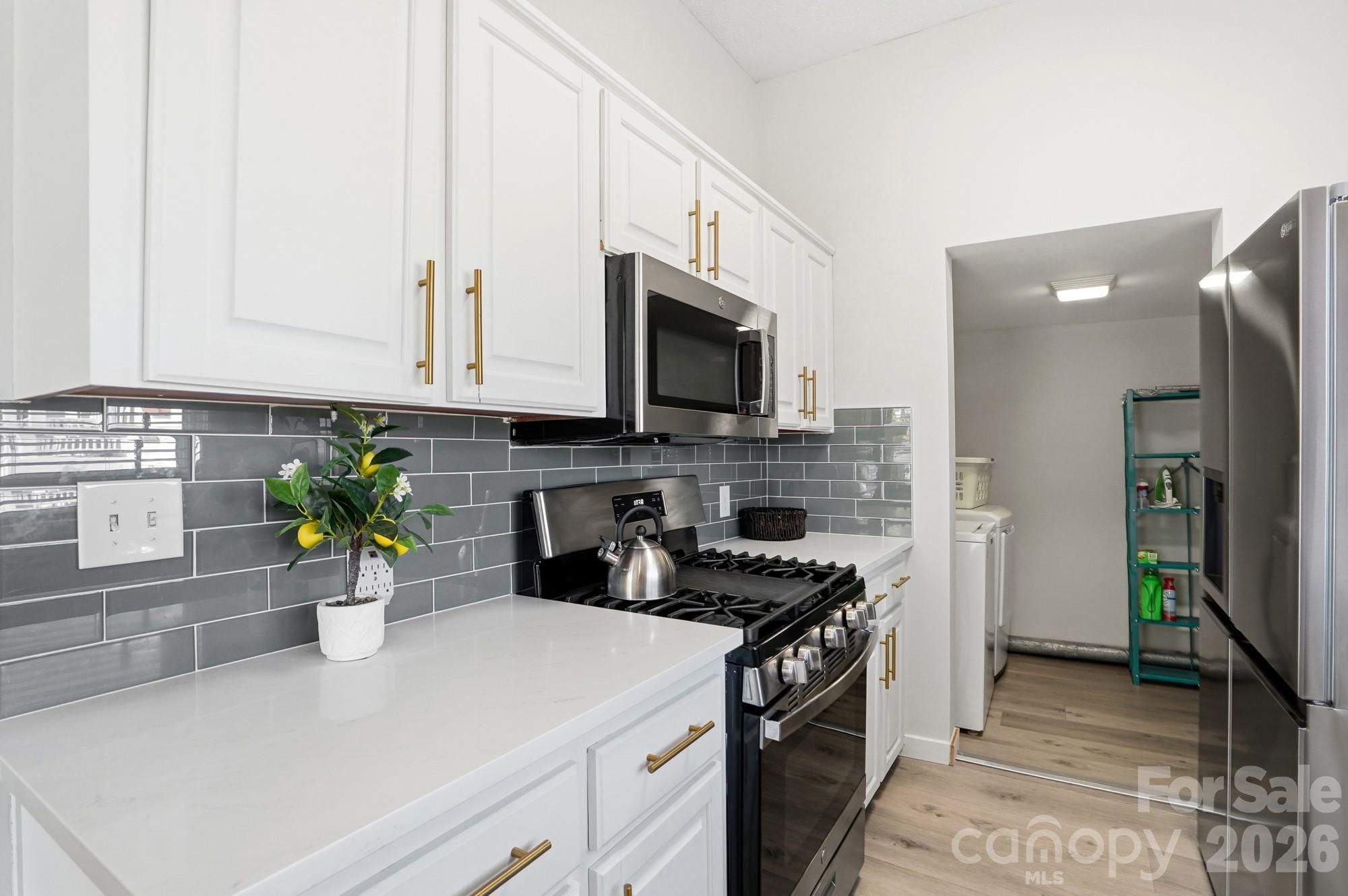 128 Massey Street Fort Mill, SC 29715 - Photo 11 of 29 a kitchen with a microwave a stove and cabinets