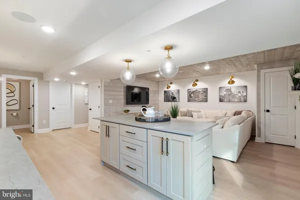 a spacious bathroom with a granite countertop sink a mirror and a bathtub