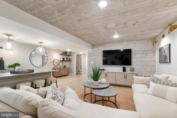 a living room with furniture a flat screen tv and a large window