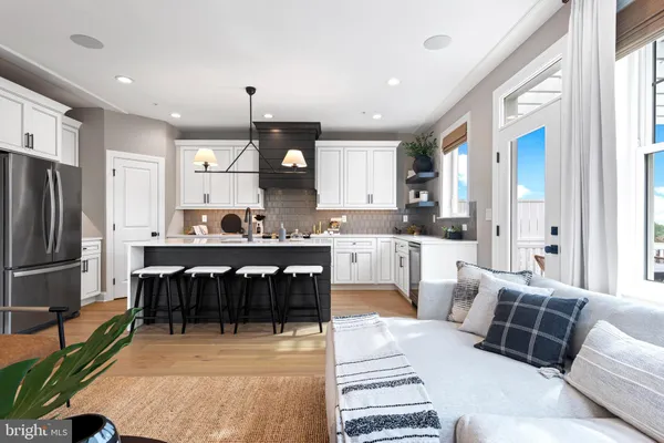 a living room with furniture a fireplace and a large window