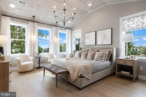 a bedroom with a large bed and a couch